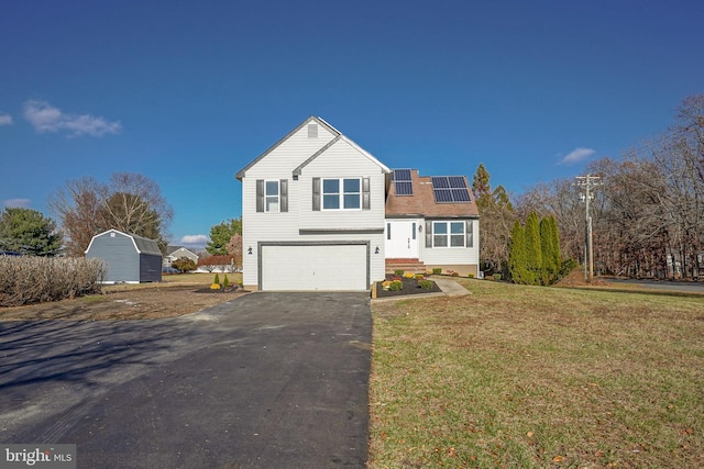 front of property featuring solar panels, a garage, and a front lawn