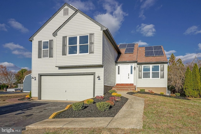 view of front of house featuring a front lawn, a garage, and solar panels