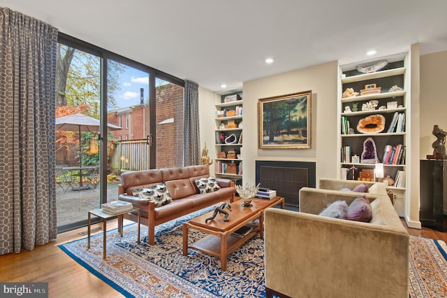 living area featuring hardwood / wood-style flooring and floor to ceiling windows