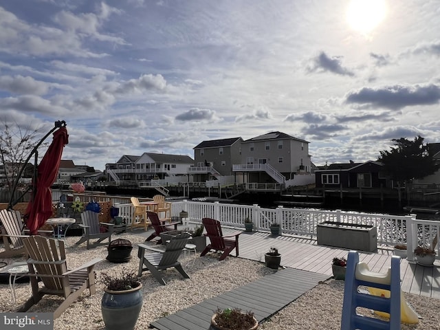 view of patio with a fire pit and a wooden deck