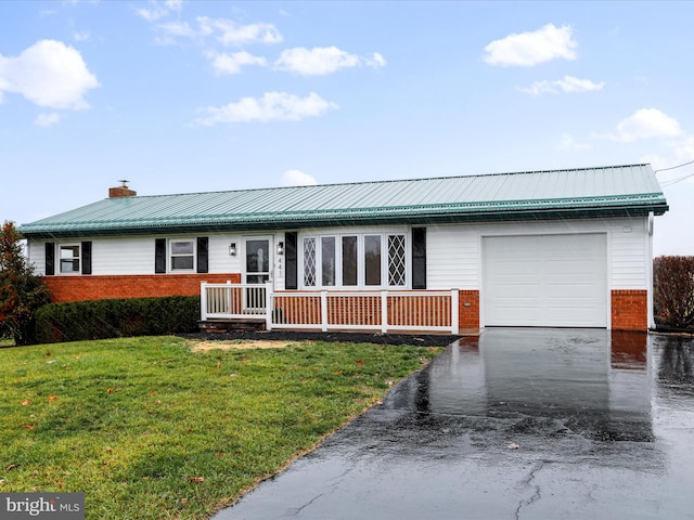 ranch-style home with a garage and a front lawn