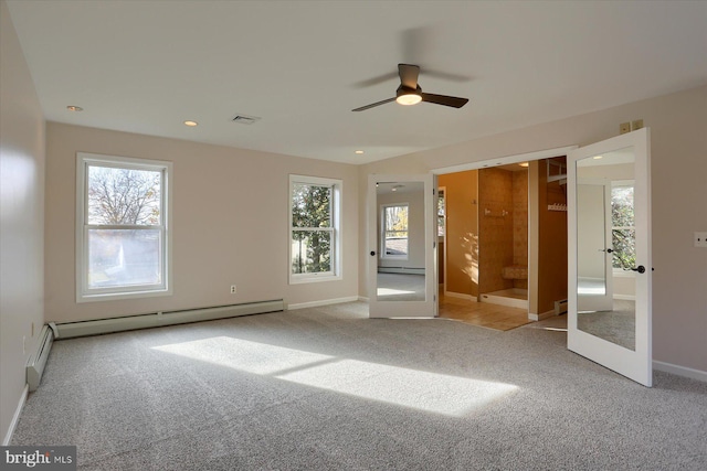 spare room with light carpet, french doors, a baseboard radiator, and ceiling fan