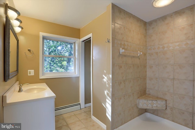 bathroom with tile patterned floors, vanity, and a baseboard heating unit