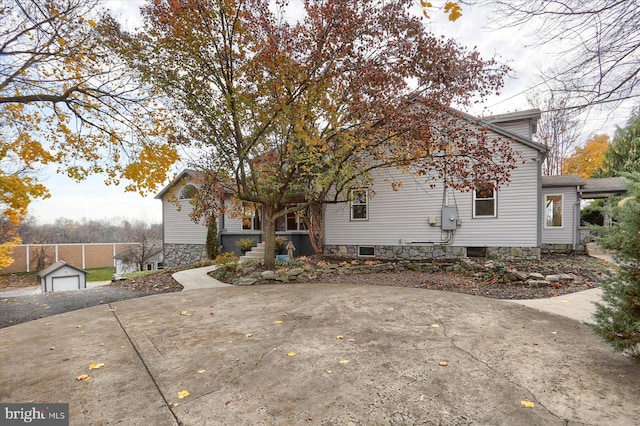 exterior space with a garage and an outbuilding