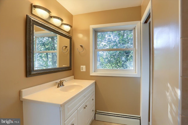 bathroom featuring baseboard heating, tile patterned floors, plenty of natural light, and vanity