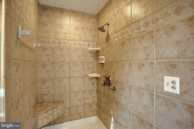 bathroom with tiled shower