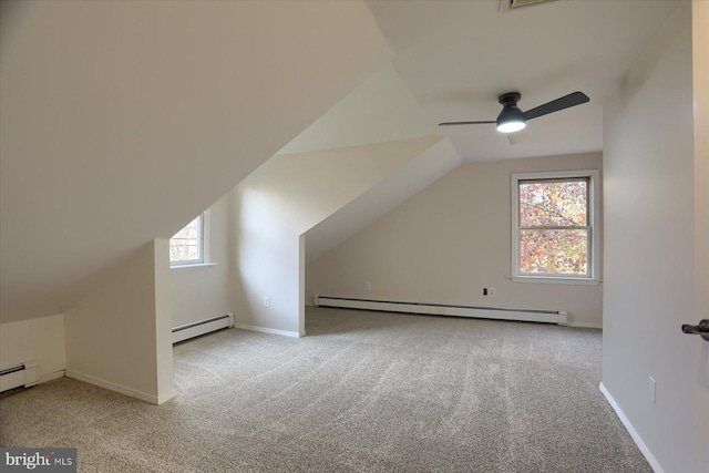 additional living space with a healthy amount of sunlight, baseboard heating, and vaulted ceiling