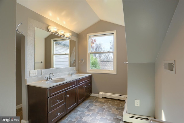 bathroom with vanity, vaulted ceiling, and a baseboard heating unit