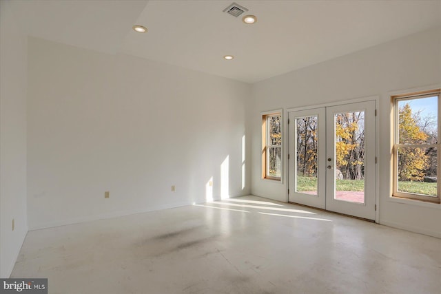 unfurnished room featuring french doors