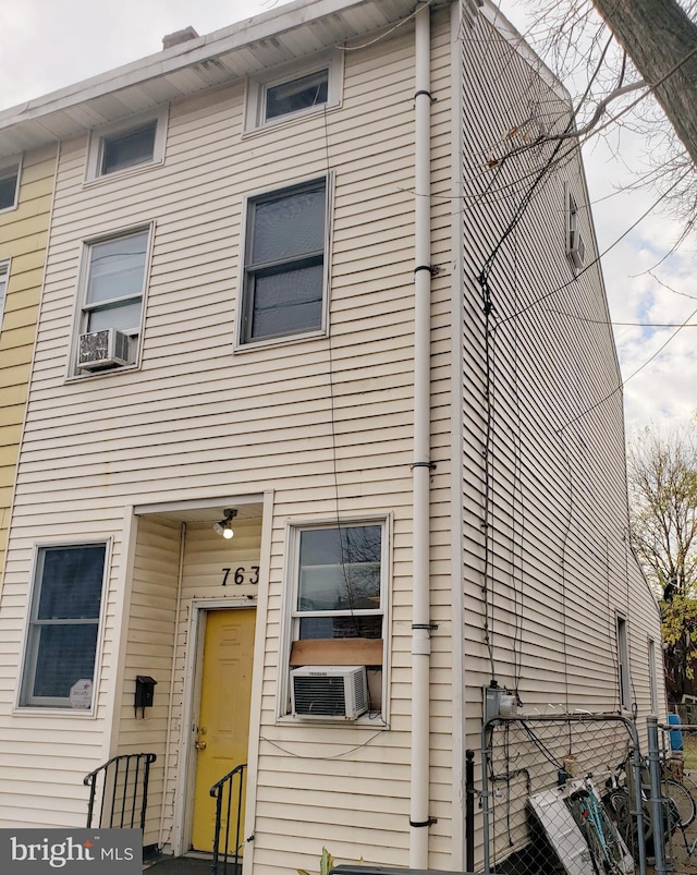 rear view of house with cooling unit