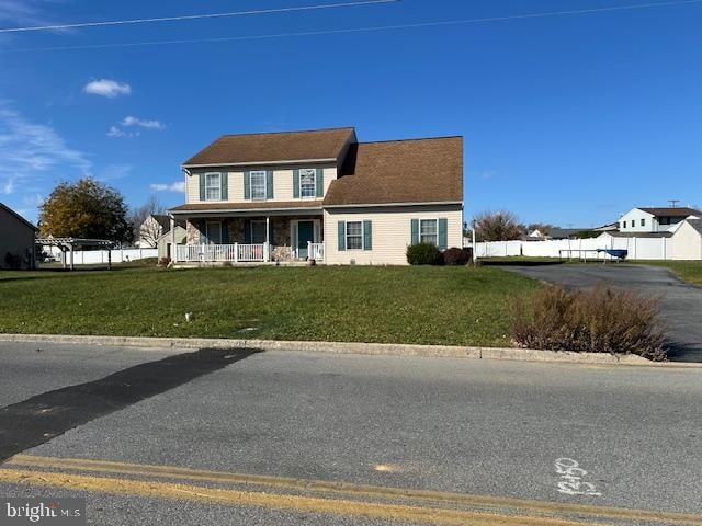 view of front of house with a porch and a front yard