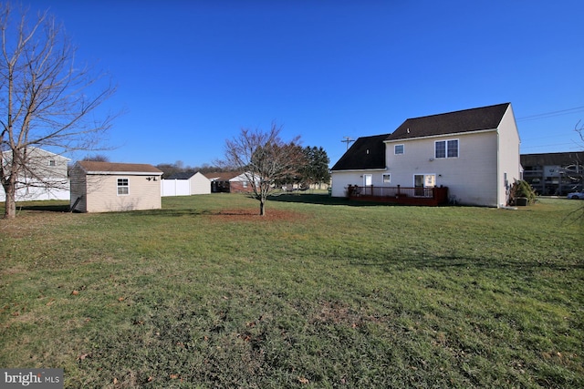 view of yard with a storage unit and a wooden deck