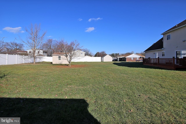 view of yard with a deck and a storage shed