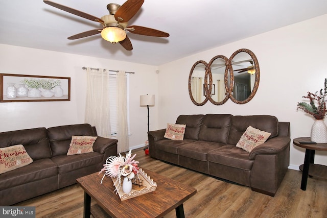 living room featuring ceiling fan and wood-type flooring