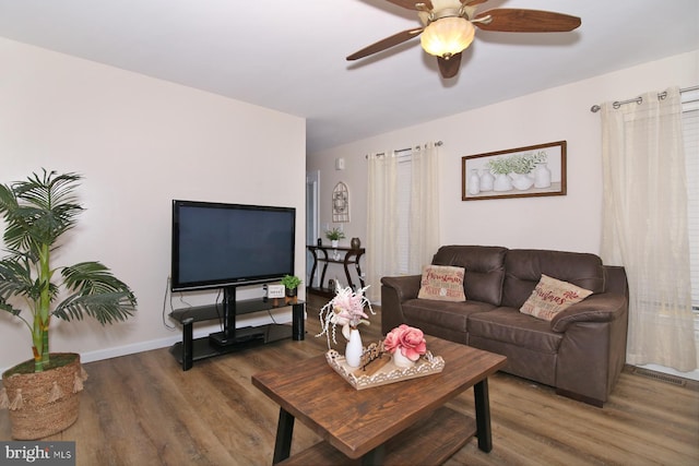 living room with dark hardwood / wood-style floors and ceiling fan