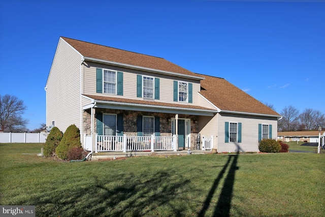 colonial home with a porch and a front yard