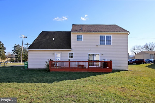 rear view of house with a yard and a deck