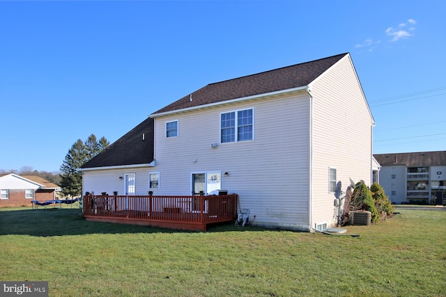 rear view of house with a deck, a yard, and central air condition unit