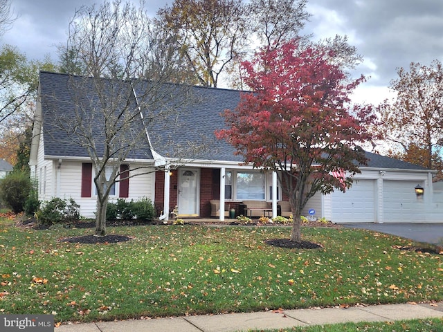 view of front of property featuring a garage and a front lawn