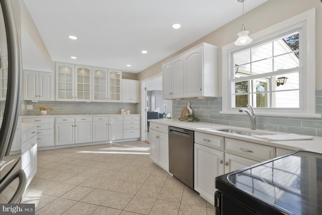 kitchen with white cabinetry, sink, decorative light fixtures, and appliances with stainless steel finishes