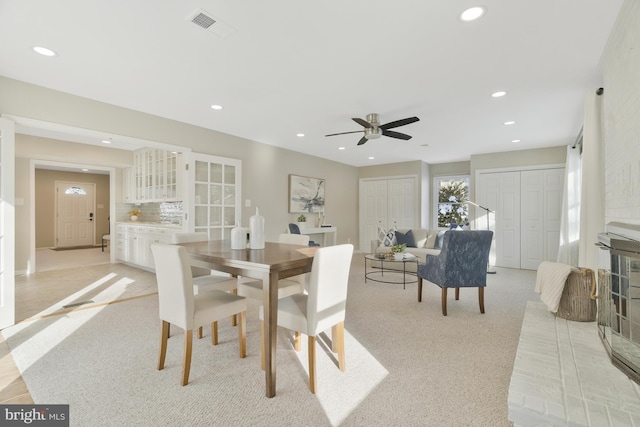 dining room featuring ceiling fan and light colored carpet