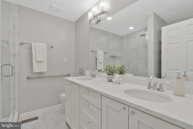 bathroom with toilet, vanity, and walk in shower