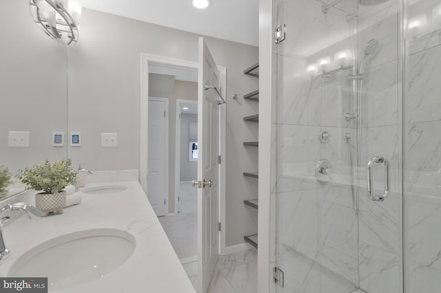 bathroom featuring a shower with door and vanity