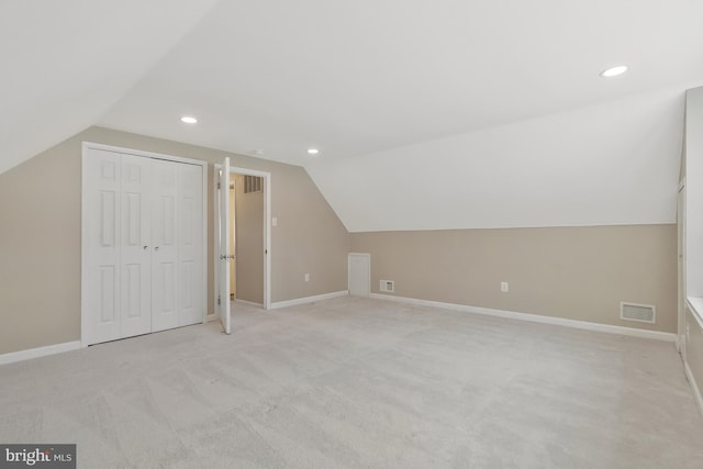 bonus room featuring light carpet and vaulted ceiling