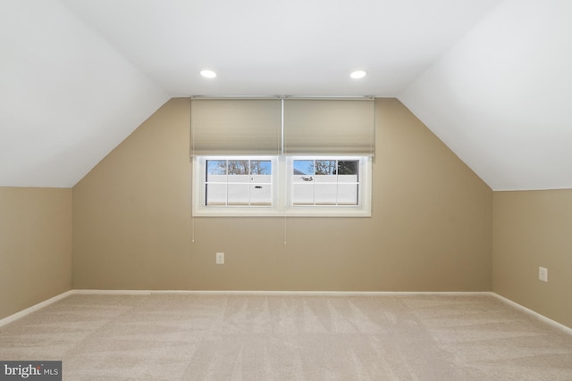 bonus room featuring light colored carpet and vaulted ceiling