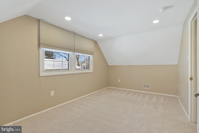 bonus room with carpet flooring and lofted ceiling