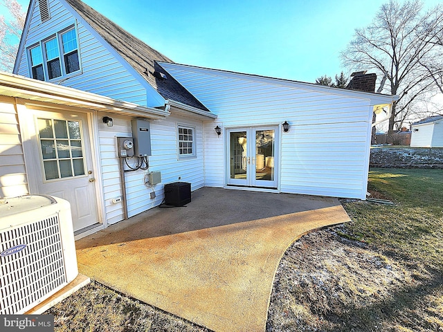 back of property with a patio area, french doors, and central AC unit