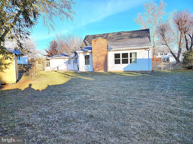 back of house with a lawn