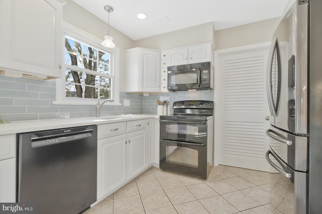 kitchen with black appliances, light tile patterned flooring, white cabinets, and hanging light fixtures