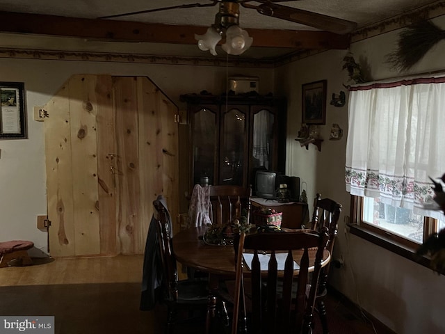 dining room with beam ceiling, a textured ceiling, and ceiling fan