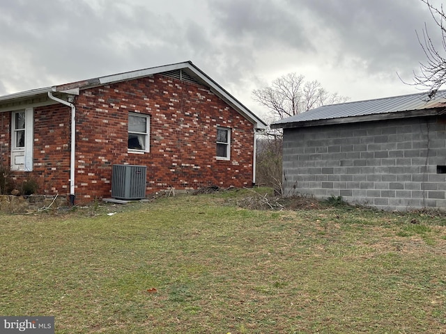 560 Frosty Hollow Rd, Fisher, WV 26818 - view of property exterior with central AC, a lawn, and brick siding