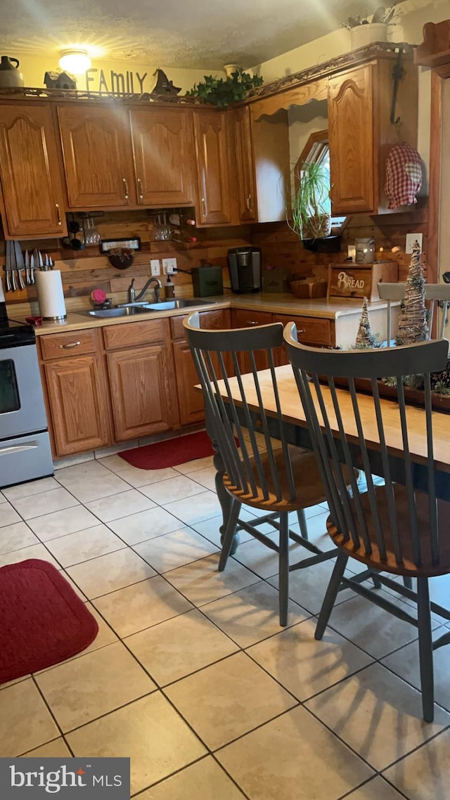 kitchen featuring light tile patterned floors and white electric range