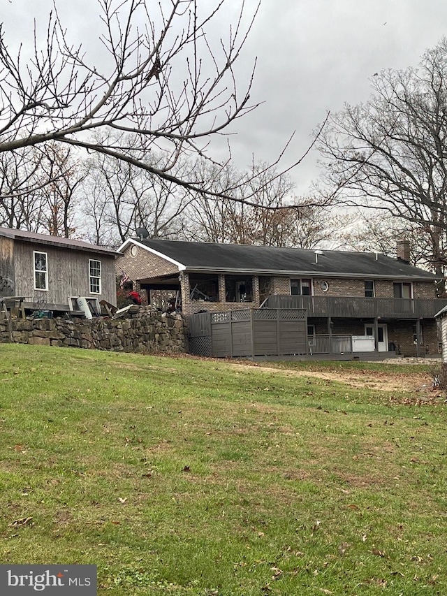 560 Frosty Hollow Rd, Fisher, WV 26818 - back of house with a lawn, a chimney, and brick siding