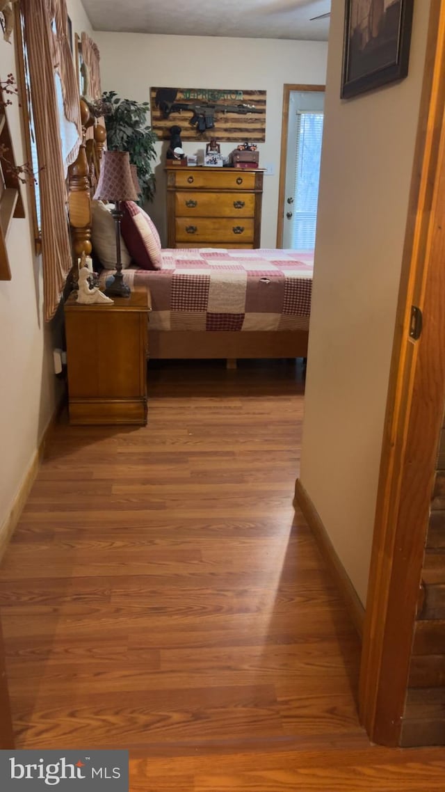 560 Frosty Hollow Rd, Fisher, WV 26818 - bedroom featuring wood finished floors and baseboards