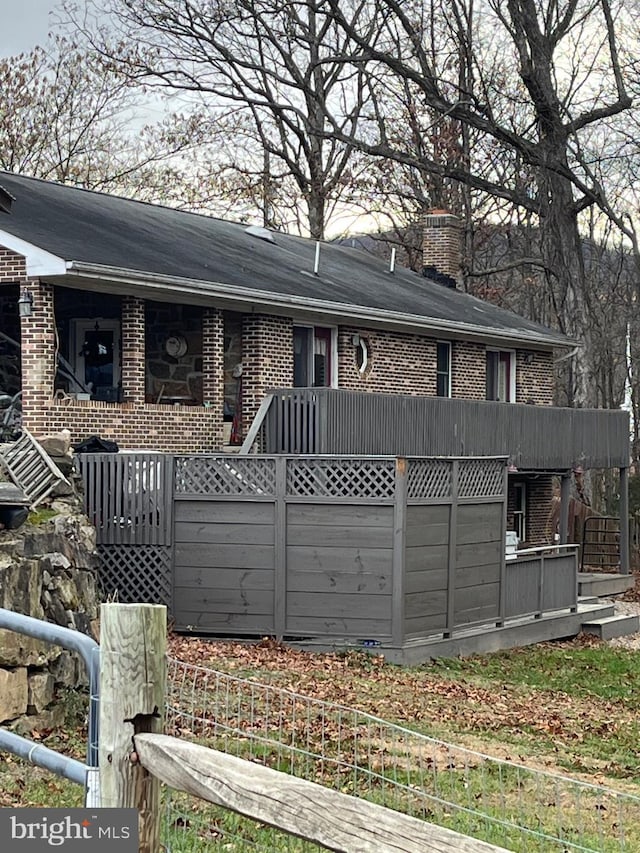 560 Frosty Hollow Rd, Fisher, WV 26818 - rear view of property with brick siding and a chimney