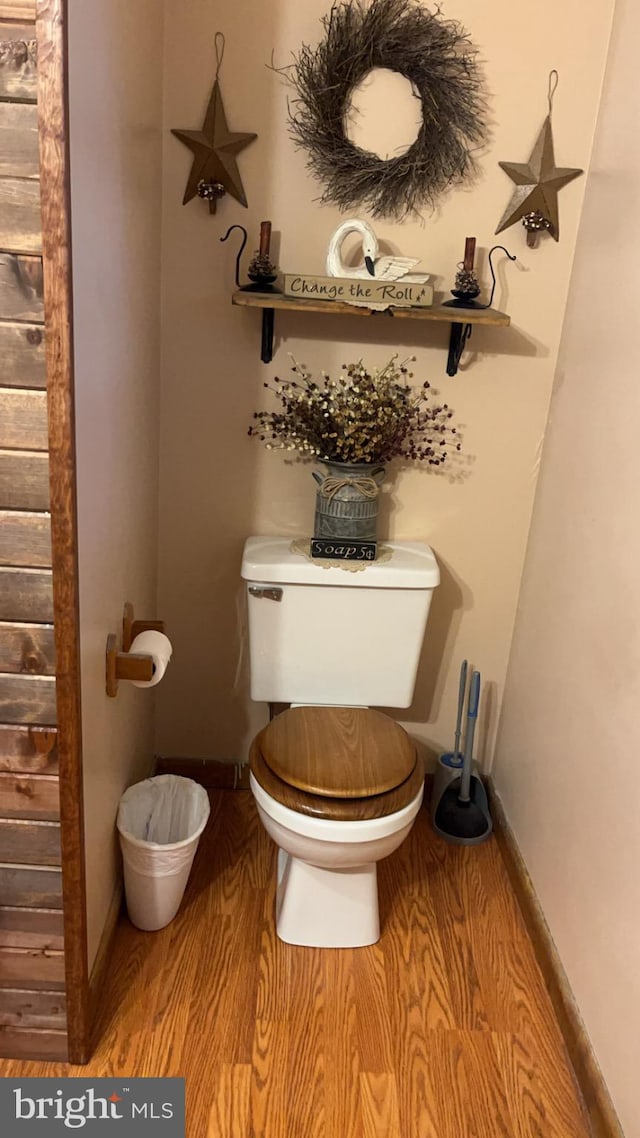 bathroom with wood-type flooring and toilet