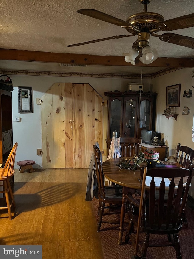 560 Frosty Hollow Rd, Fisher, WV 26818 - dining room with ceiling fan, a textured ceiling, and wood finished floors