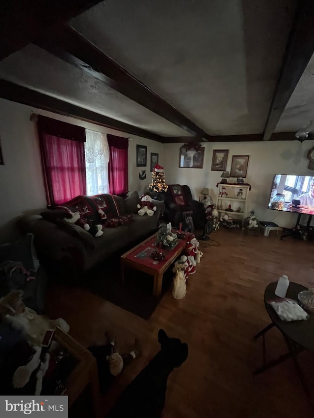 living room featuring beamed ceiling and wood-type flooring