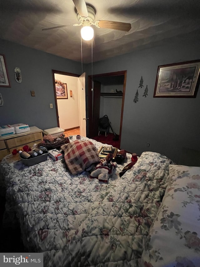 bedroom featuring ceiling fan and a closet