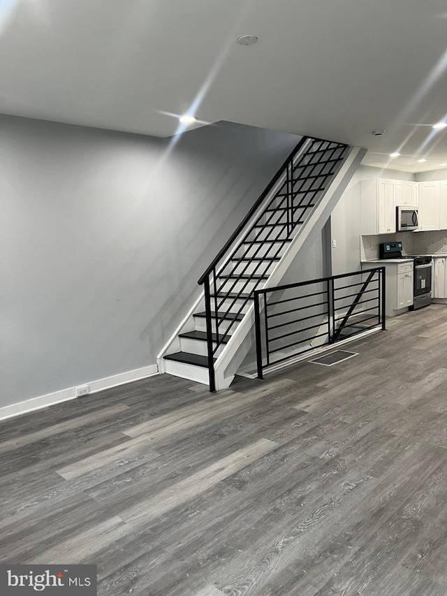 staircase with wood-type flooring