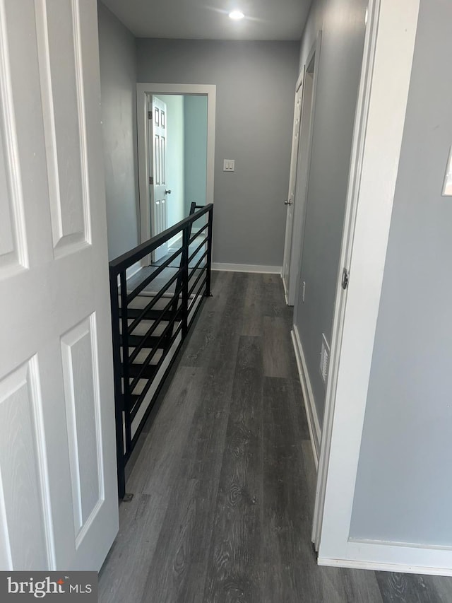 hallway featuring dark hardwood / wood-style flooring