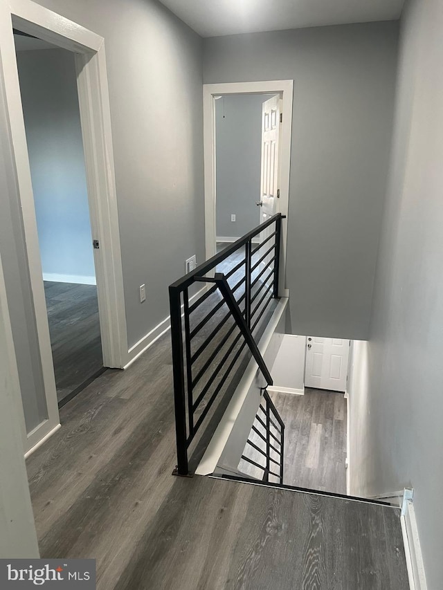 stairway with hardwood / wood-style flooring