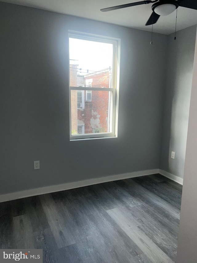 spare room with ceiling fan and wood-type flooring