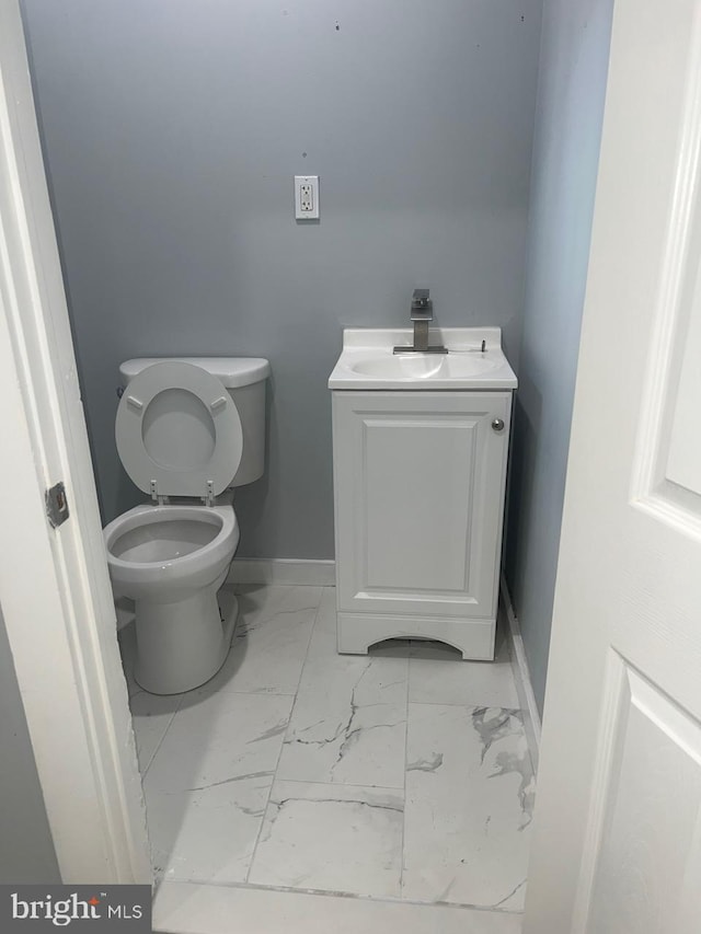 bathroom featuring vanity and toilet