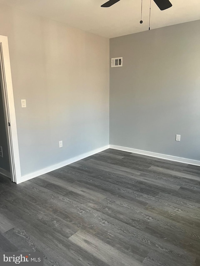 empty room featuring ceiling fan and dark hardwood / wood-style flooring