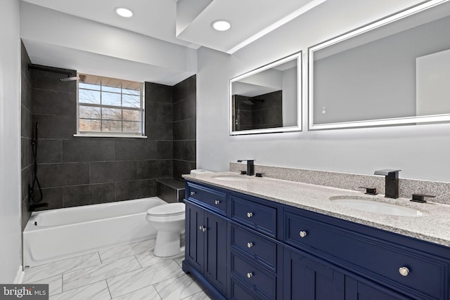 full bathroom with vanity, tiled shower / bath combo, and toilet